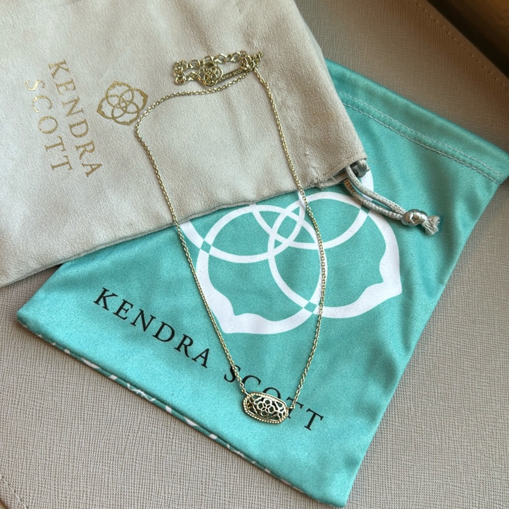 Gold Kendra Scott necklace.